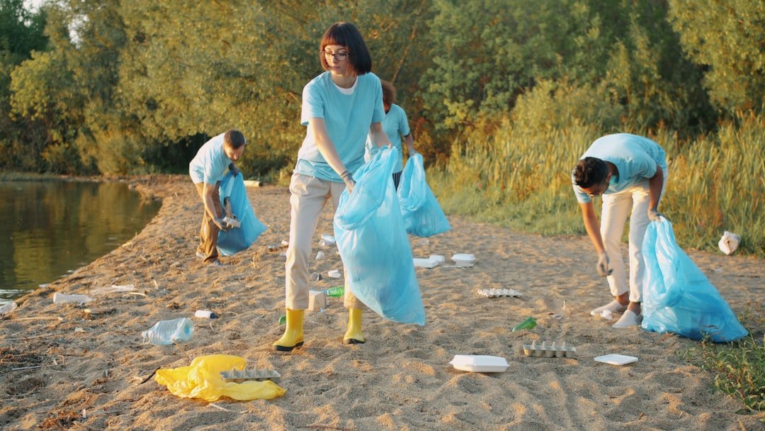 about-01 Multi-ethnic group of students hard-working people are cleaning beach from pollution during Earth day. Environmental problems and conscious youth concept.